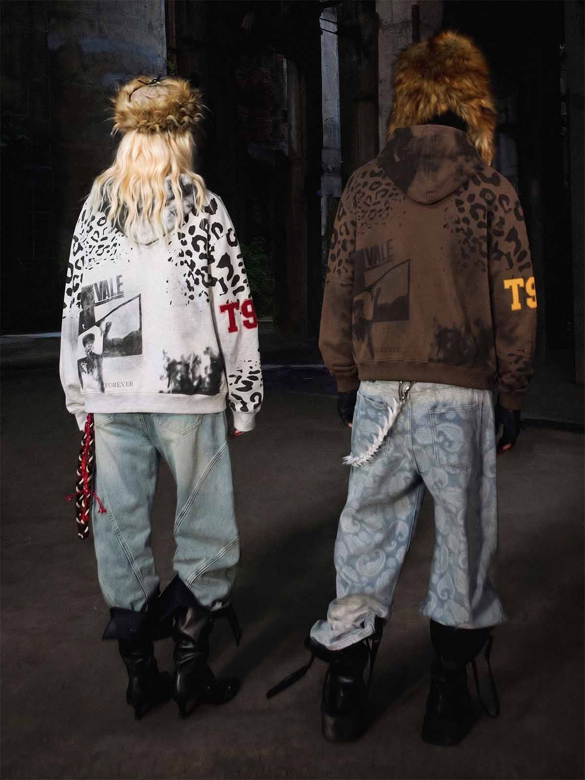 Leopard graphic hoodie styled with paneled jeans and tall black boots