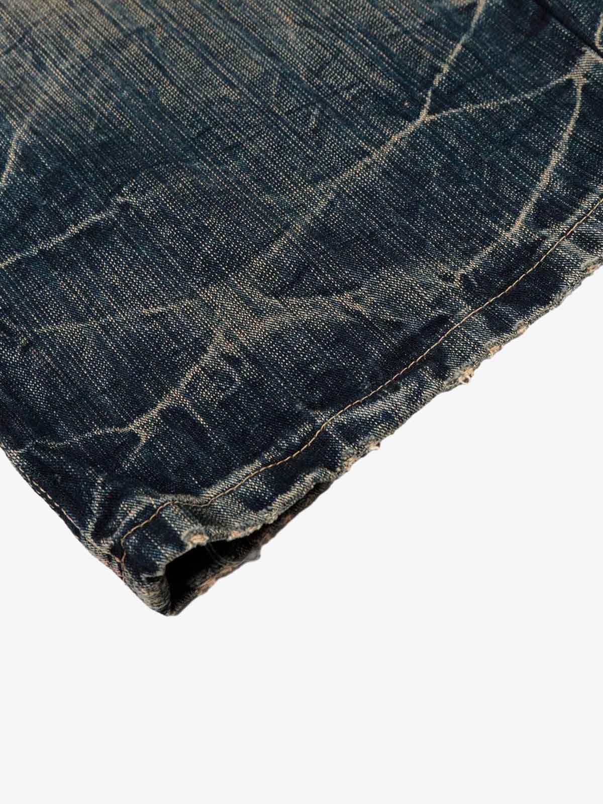 Dirty Wash Distressed Curved Blade Denim Jeans