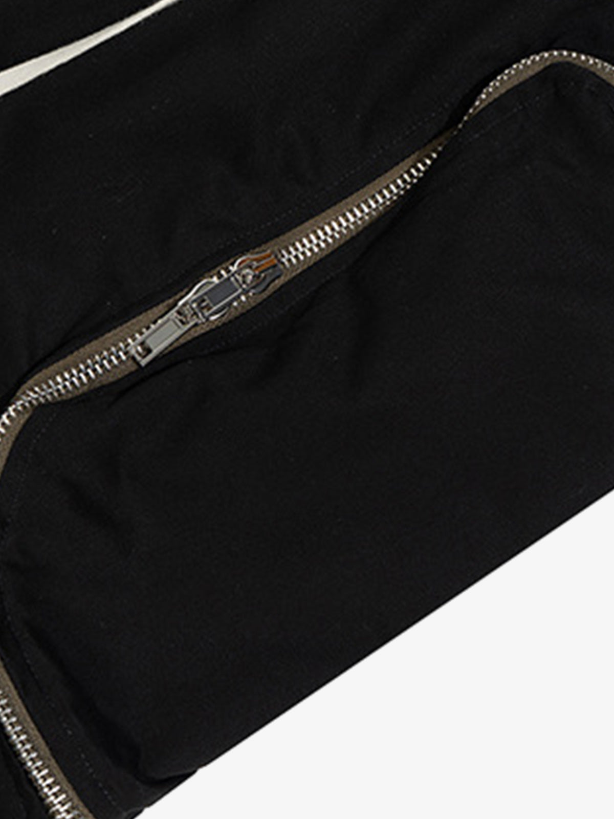 Close-up of metal zipper pocket on black nylon cargo pants