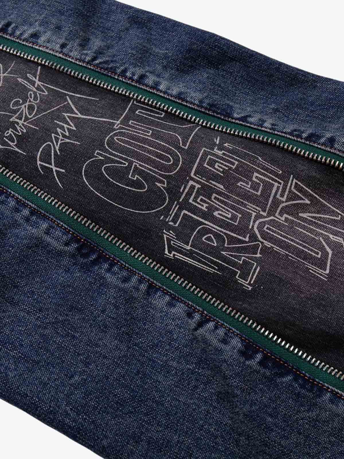 Wide-Leg Denim Jeans with Unique Zipper Design and Graffiti Artwork 