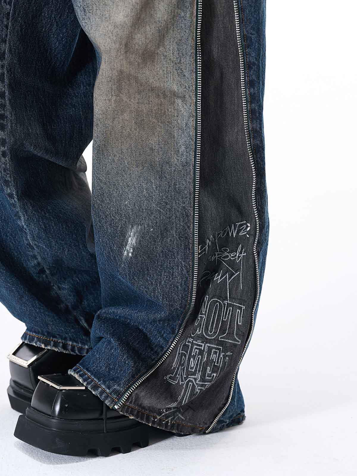 Wide-Leg Denim Jeans with Unique Zipper Design and Graffiti Artwork 