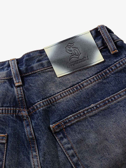 Wide-Leg Denim Jeans with Unique Zipper Design and Graffiti Artwork 