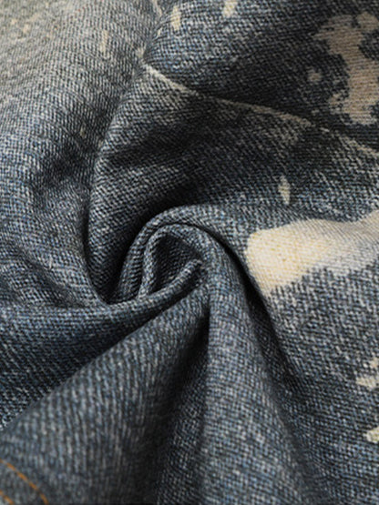 Distressed heavy-duty painted straight-leg jeans, adorned with red graffiti prints and paint-splatter wash effects 