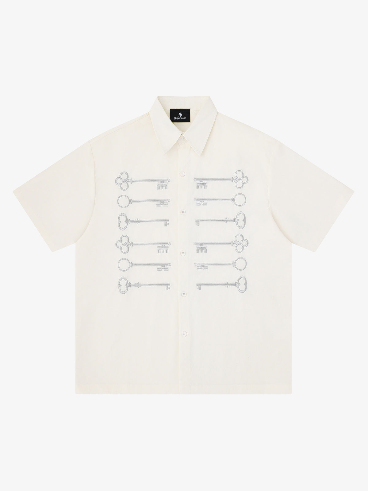 Camisa negra de algodón con botones y motivo de llave bordado en dorado.