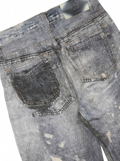 Distressed heavy-duty painted straight-leg jeans, adorned with red graffiti prints and paint-splatter wash effects 