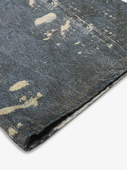 Distressed heavy-duty painted straight-leg jeans, adorned with red graffiti prints and paint-splatter wash effects 