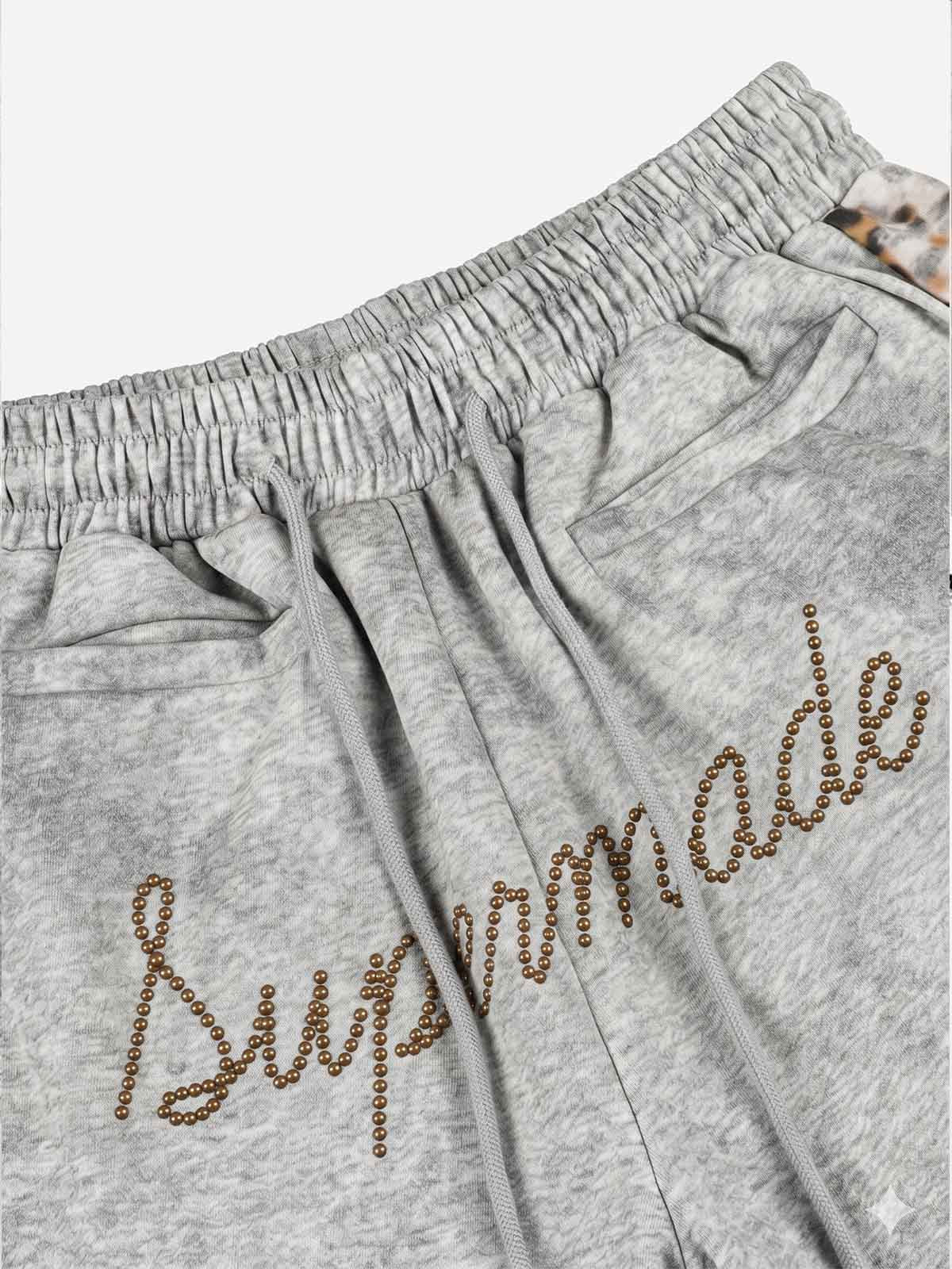 Pantalon de survêtement patchwork léopard avec logo strass