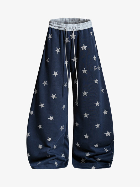 Pantaloni con stampa a stelle e cintura a blocchi di colore