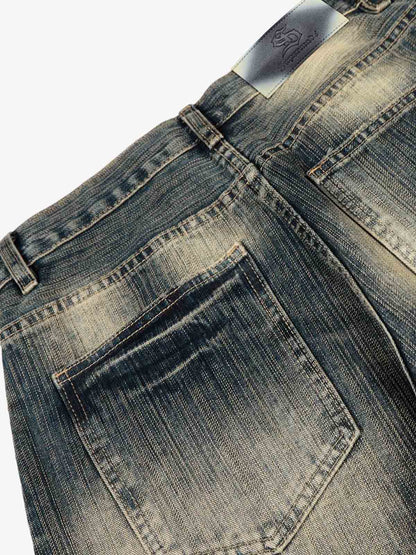 Dirty Wash Distressed Curved Blade Denim Jeans