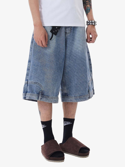 Person wearing blue denim shorts, black socks, and brown open-toe shoes on a white background