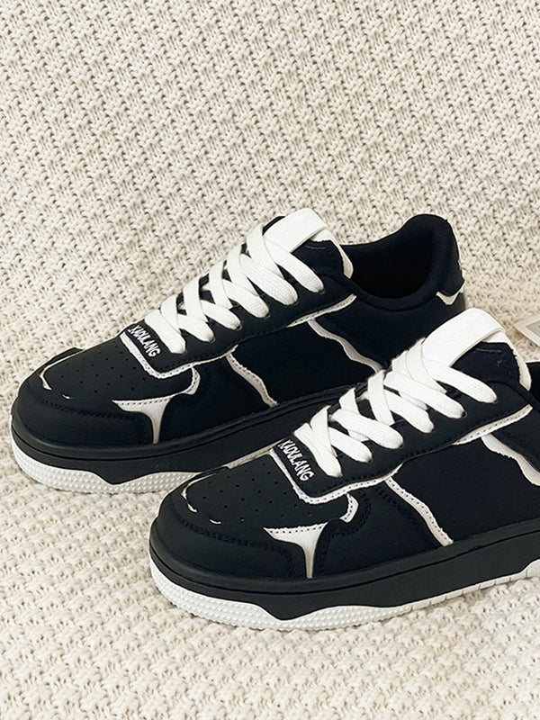 Black canvas shoes with contrasting light laces and flat soles